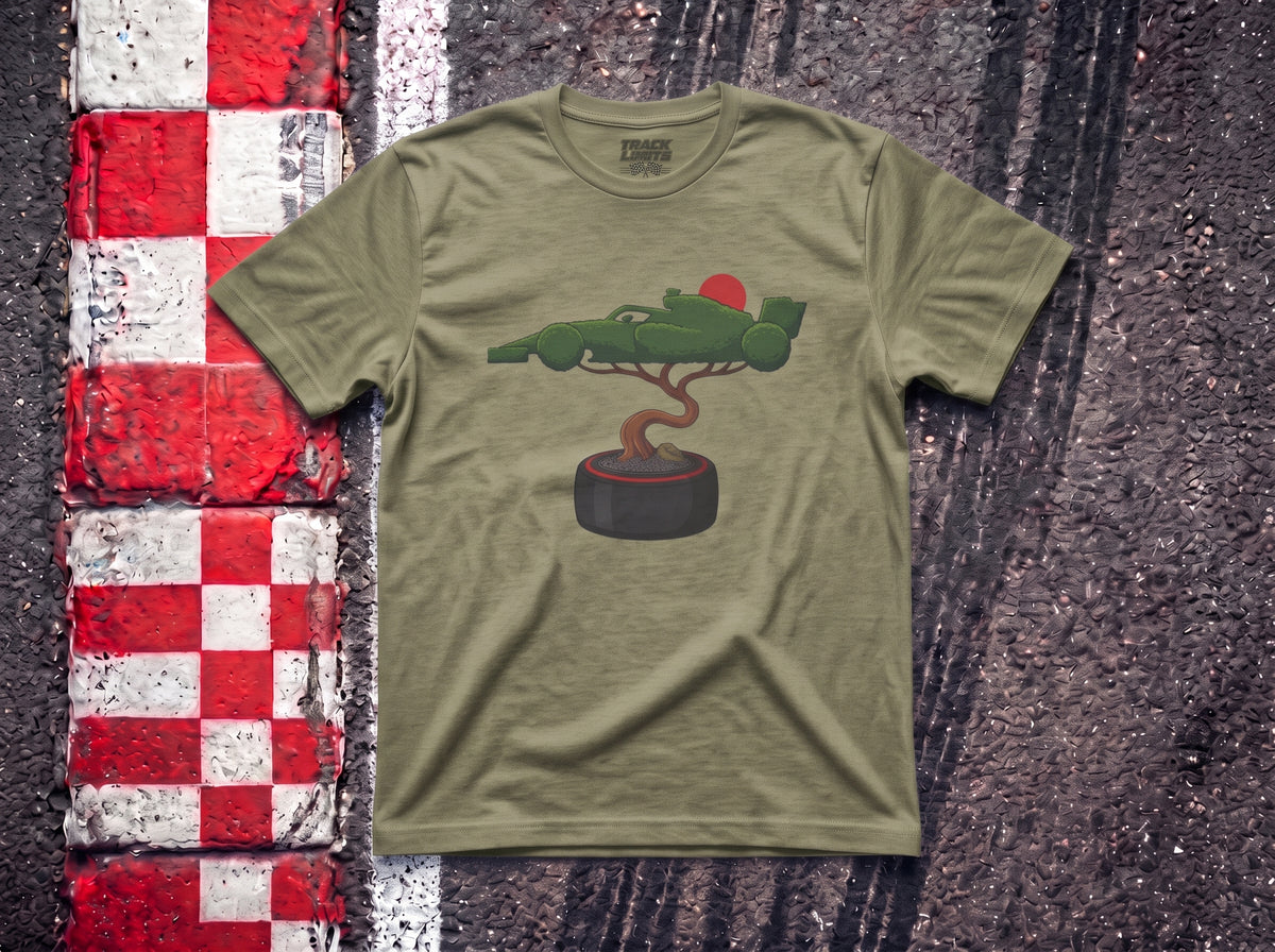 Bonsai Tree F1 t-shirt in Heather Military Green, flat lay on a race track kerb