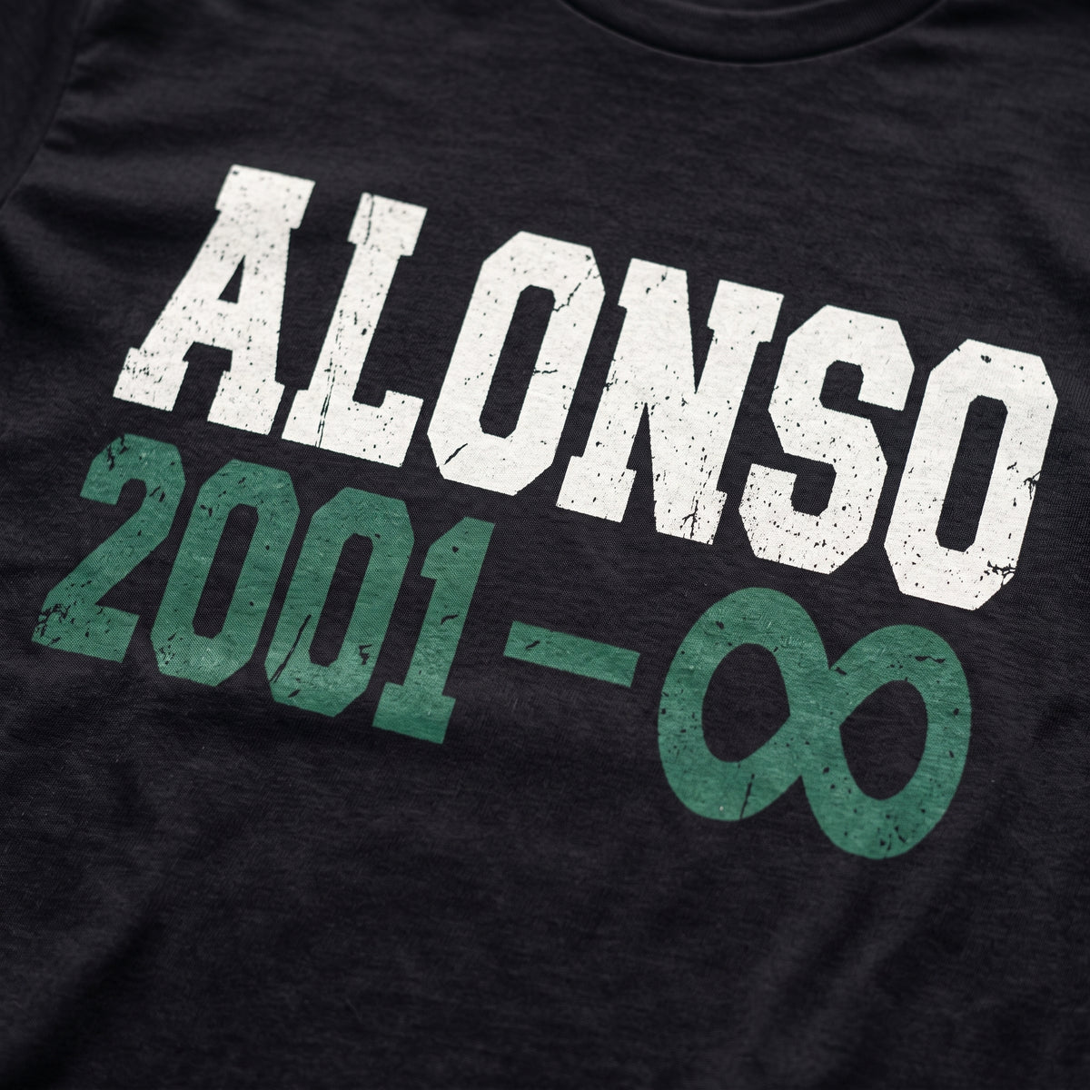 Close-up of the Alonso to Infinity F1 t-shirt print on Black cotton