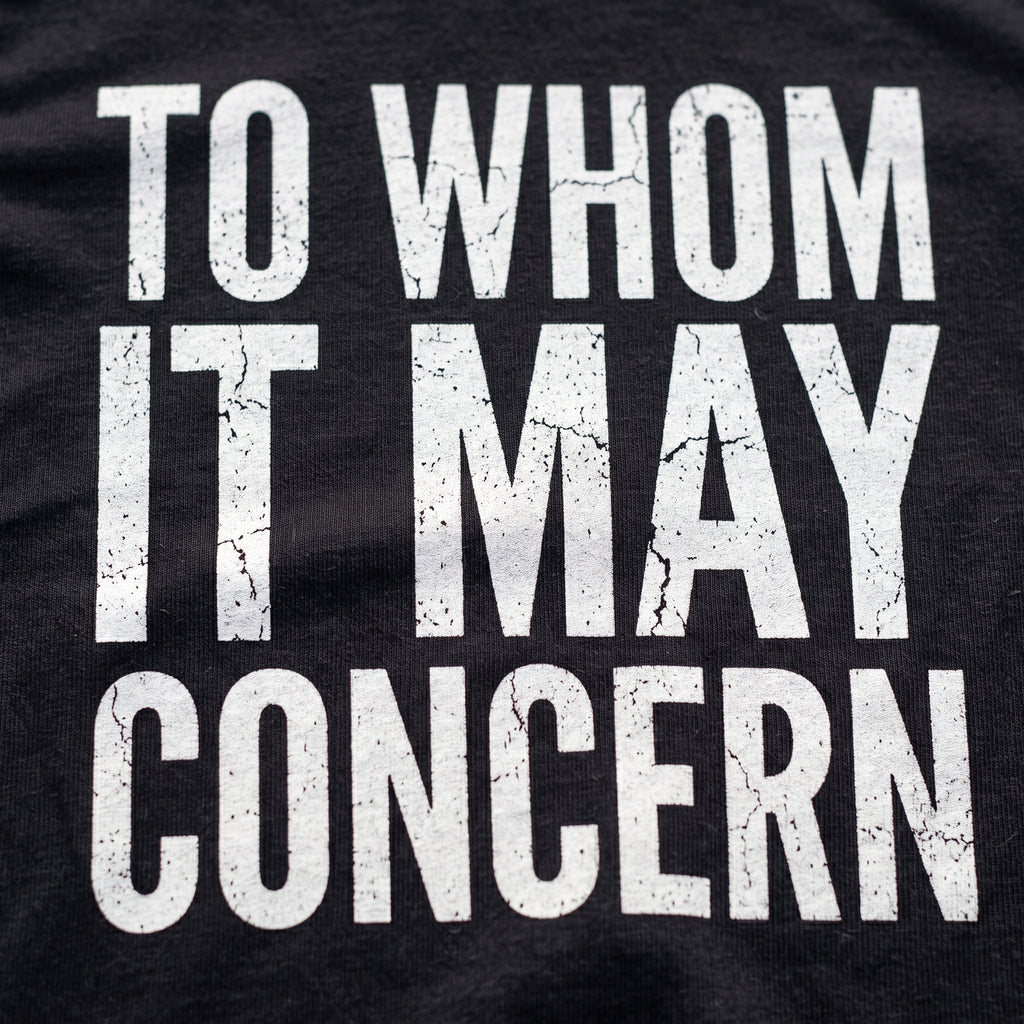 Close-up of the To Whom it May Concern F1 t-shirt print on Black cotton