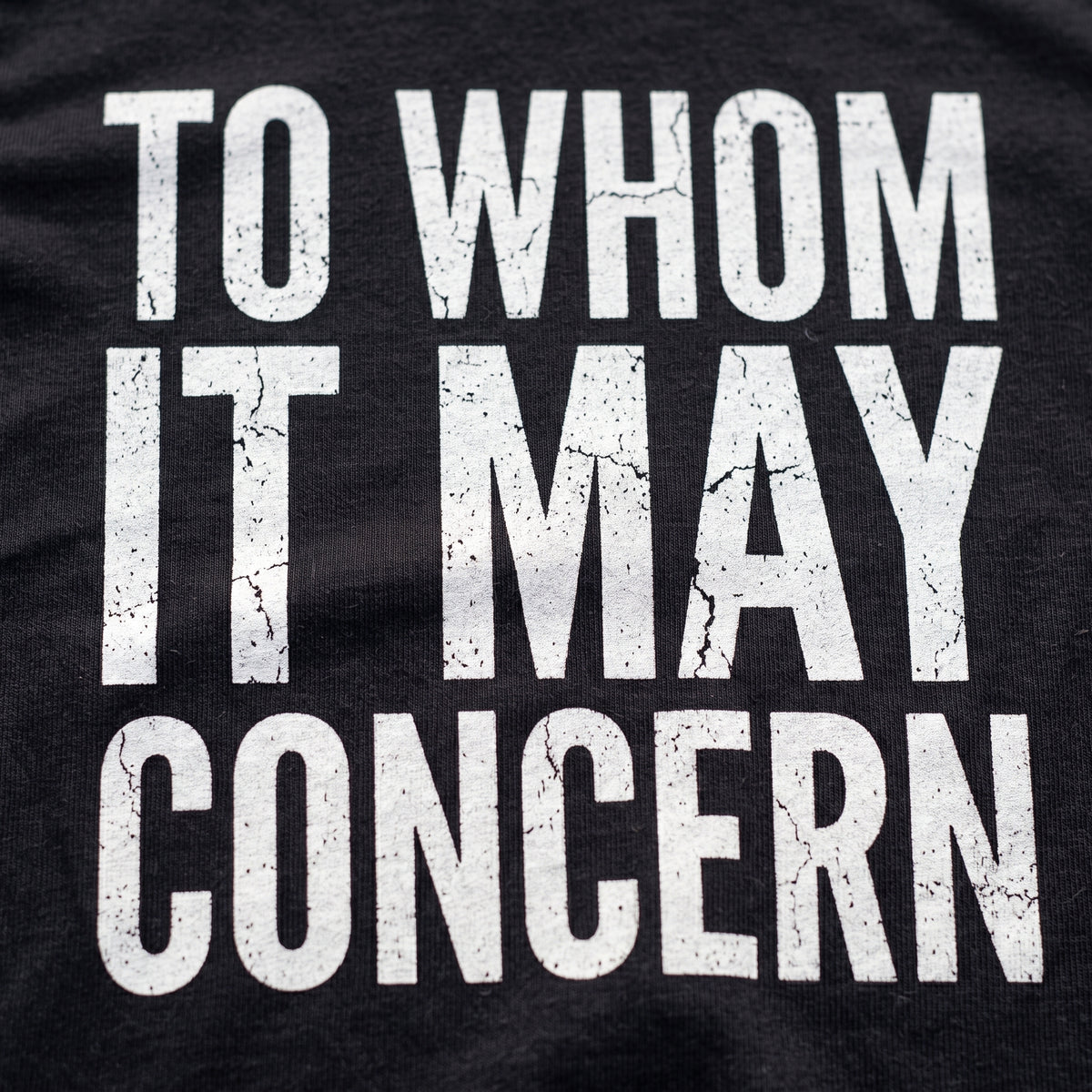 Close-up of the To Whom it May Concern F1 t-shirt print on Black cotton