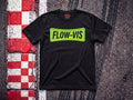 Flow-Vis F1 t-shirt in Black, flat lay on a race track kerb