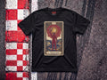 Leclerc Il Predestinato F1 t-shirt in Black, flat lay on a race track kerb