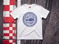 Max Delft Plate F1 t-shirt in White, flat lay on a race track kerb