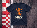 Max the Lion Heart F1 t-shirt in Navy, flat lay on a race track kerb